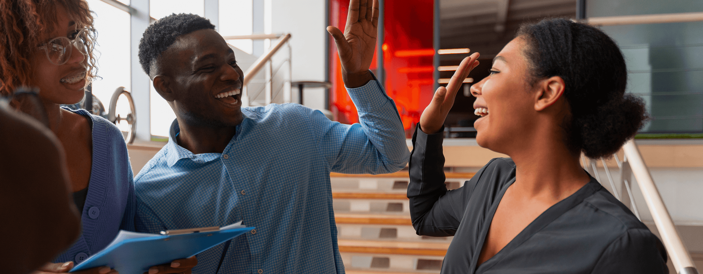 Three people high fiving